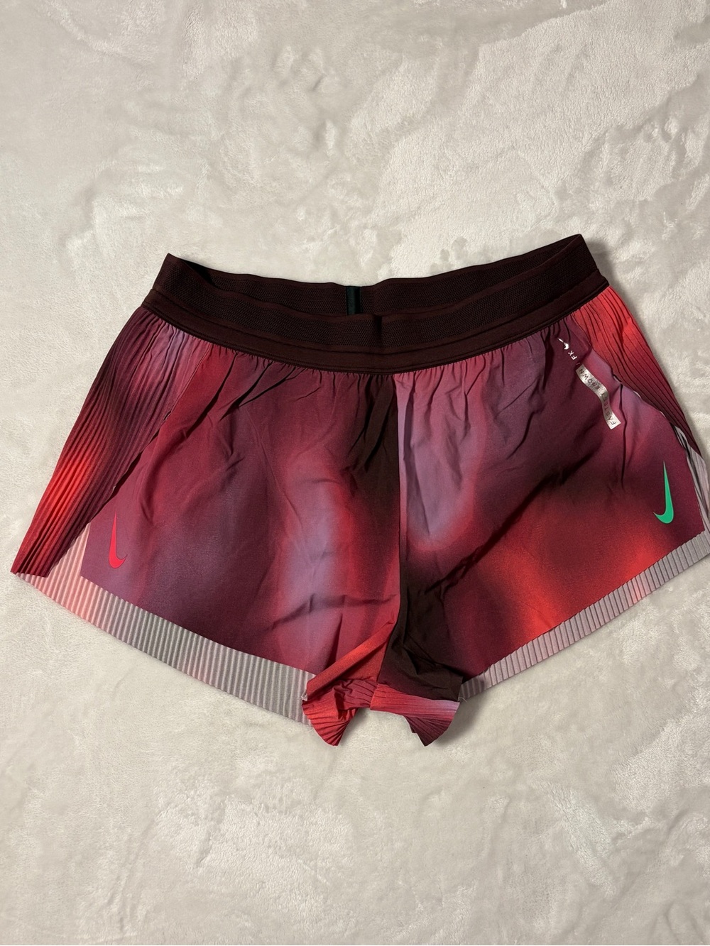 Nike Women's Maroon to Red Gradient Athletic Shorts with Green Swoosh